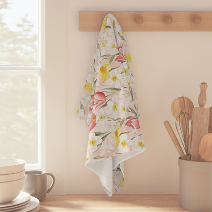 Microfiber tea towel with watercolor pink tulips and yellow daffodils, hanging on a wooden peg.
