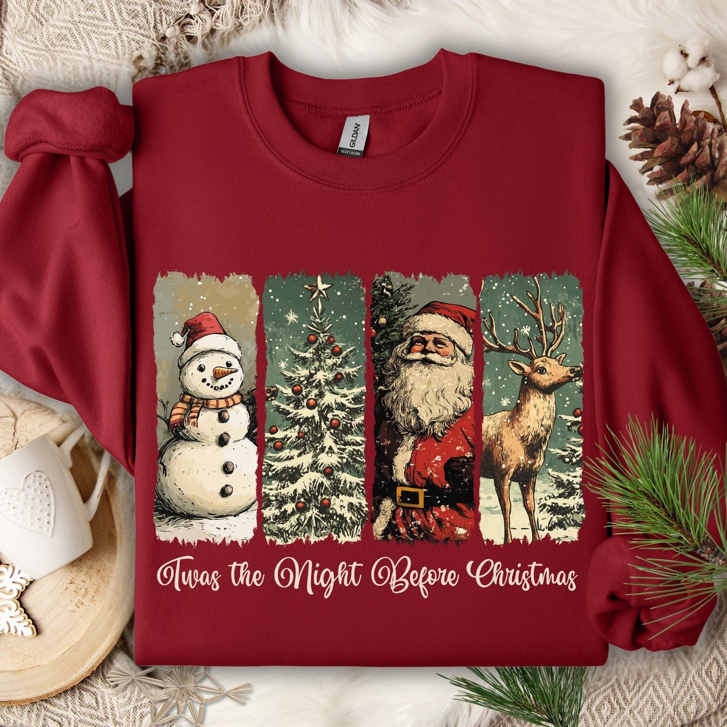 Cardinal Red Gildan sweatshirt with vintage North Pole scene: snowman, Christmas tree, Santa, reindeer, and "Twas the Night Before Christmas" text.