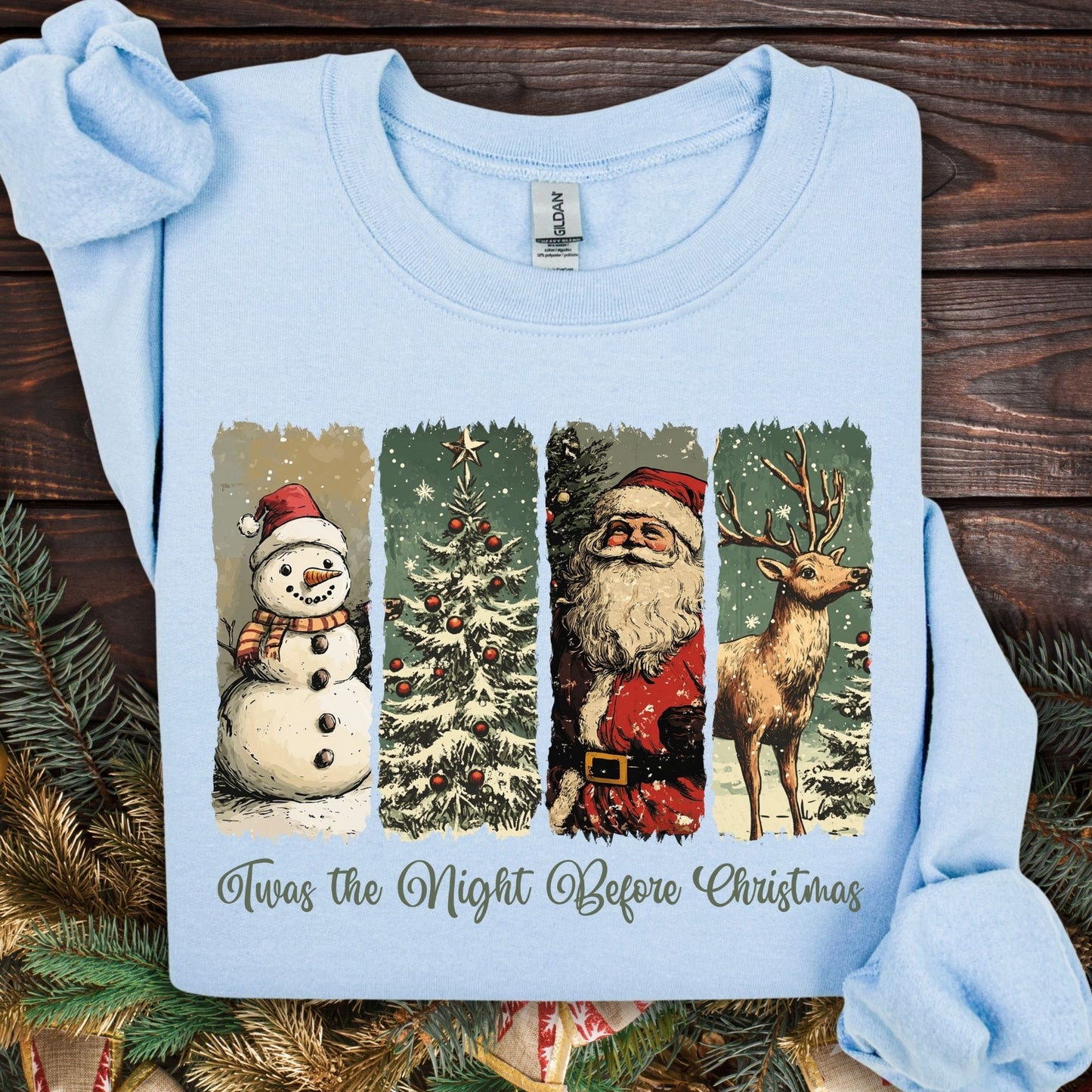 Light blue Gildan sweatshirt with vintage Santa, reindeer, snowman, and Christmas tree design.
