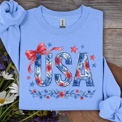 Carolina Blue USA Patriotic Floral Sweatshirt with red bow, stars, and blue/red floral lettering.