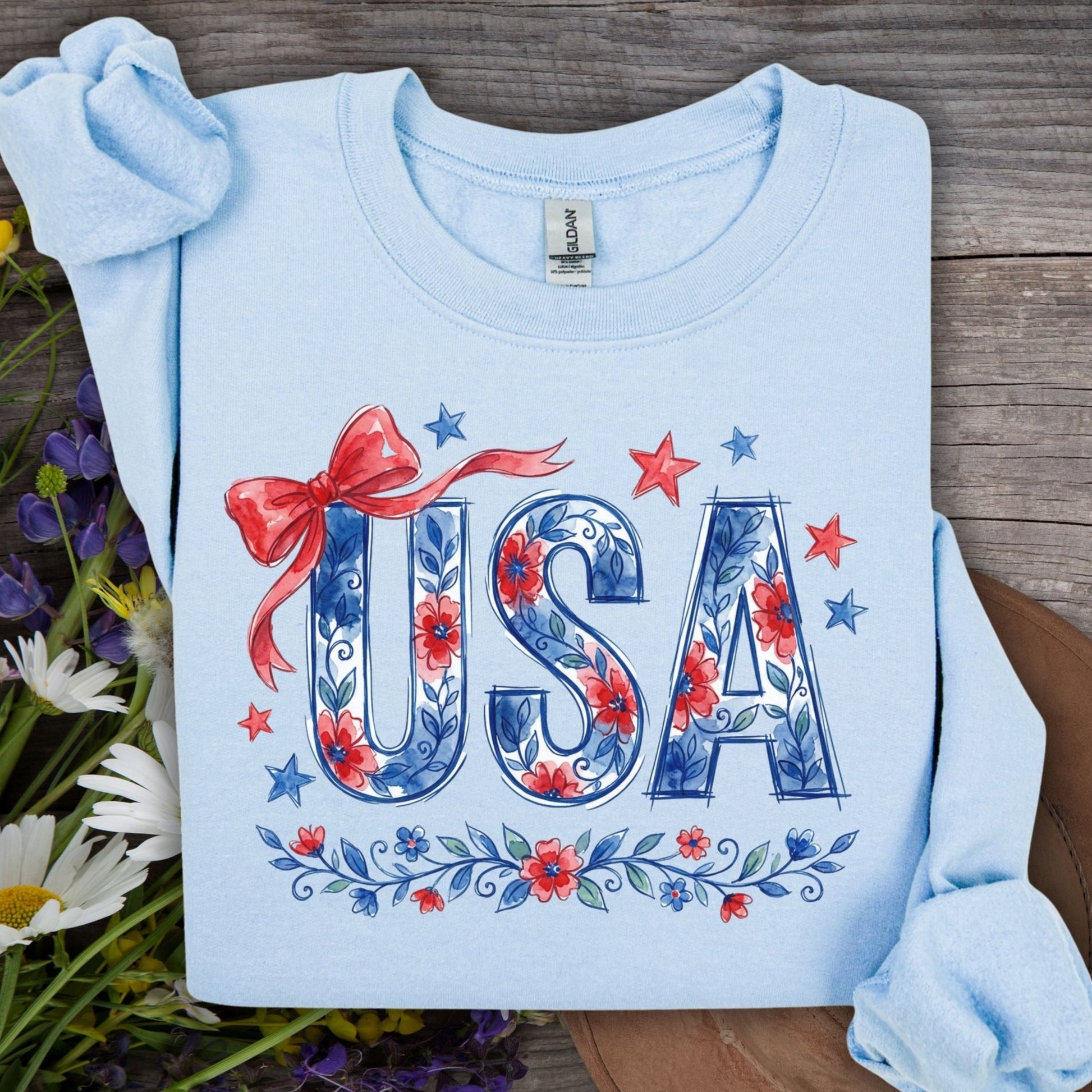 Light blue USA Patriotic Floral Sweatshirt with red bow, stars, and blue floral lettering.