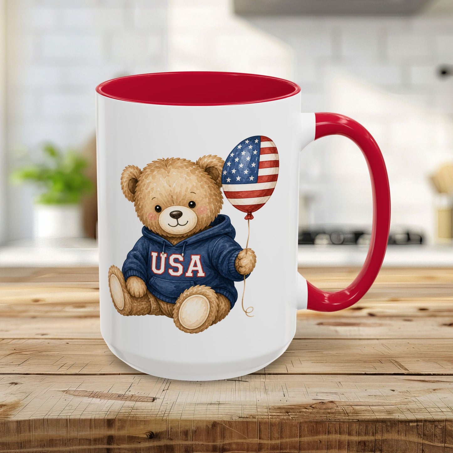 Red 15oz ceramic mug with a cute teddy bear wearing a USA hoodie and holding an American flag balloon.