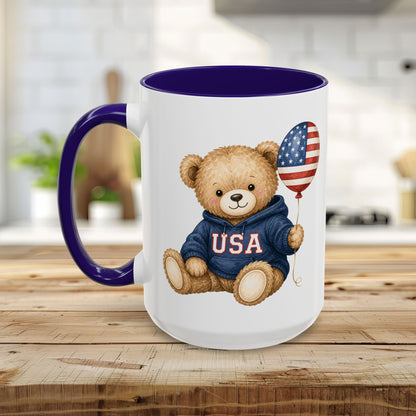Ceramic mug with a teddy bear in a USA hoodie holding an American flag balloon, purple handle and interior.
