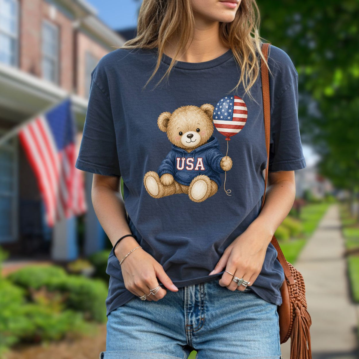 Garment-dyed navy t-shirt with a teddy bear in a USA hoodie holding a flag balloon.