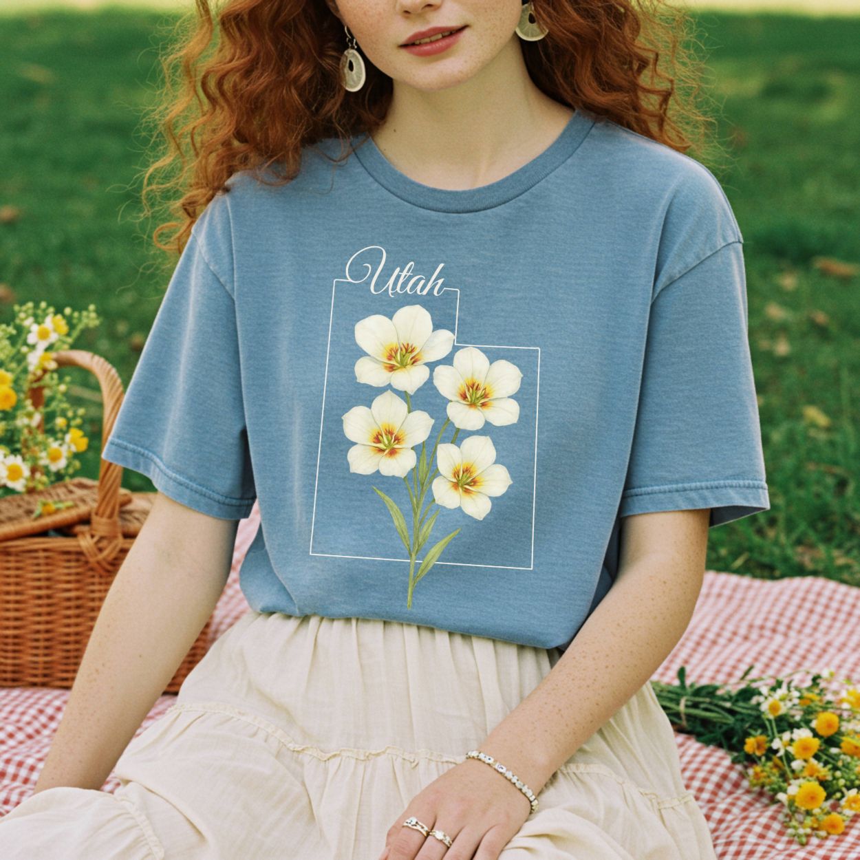 Relaxed-fit, garment-dyed blue cotton t-shirt with watercolor sego lilies and "Utah" text.