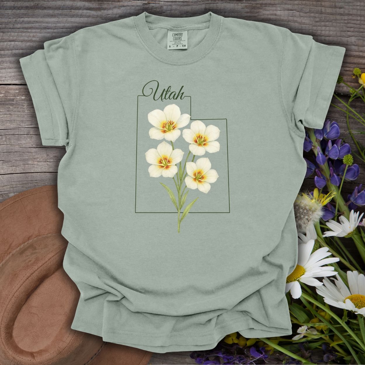 Bay S-size Utah State Flower T-Shirt with watercolor sego lilies on a subtle Utah outline.