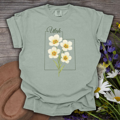 Bay S-size Utah State Flower T-Shirt with watercolor sego lilies on a subtle Utah outline.