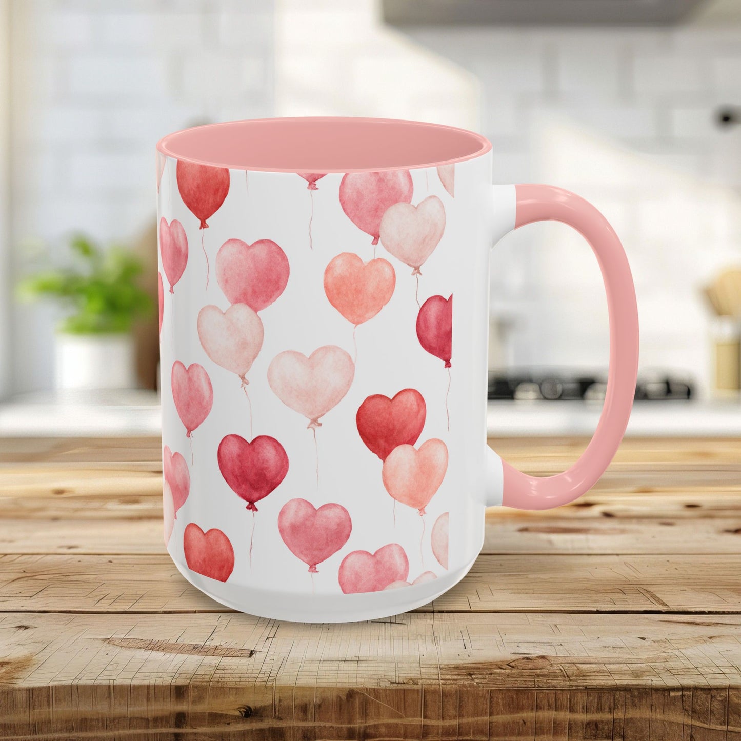 15oz ceramic mug with pink interior/handle and watercolor heart balloons in shades of pink and red.