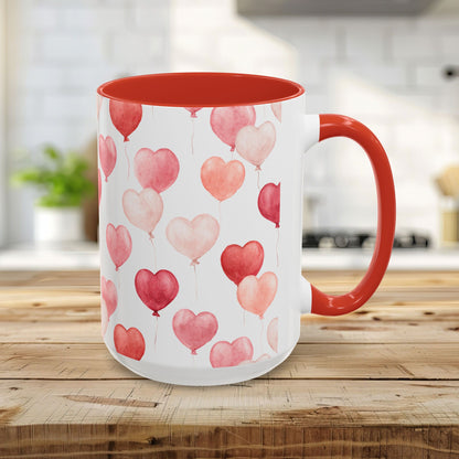 15oz white ceramic mug with watercolor pink heart balloons, red interior, and red C-shaped handle.