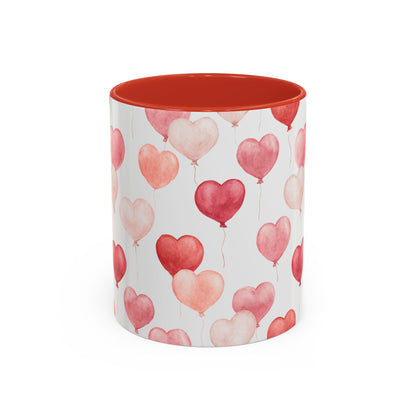 White ceramic mug with pink and red watercolor heart balloons and a red interior.