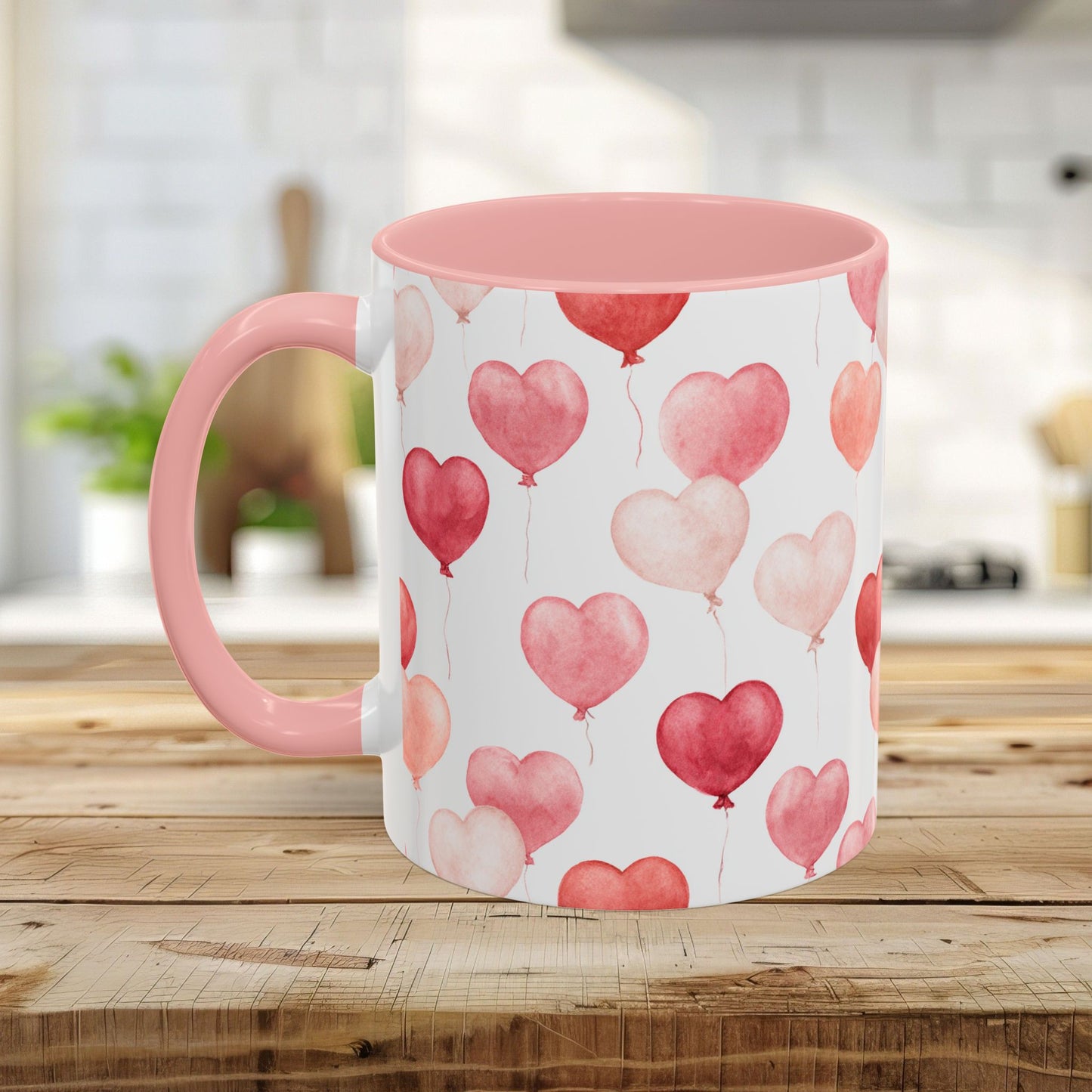 Pink watercolor heart balloon mug, 11oz or 15oz, with pink interior and handle on a wooden table.