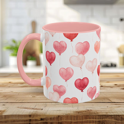 Pink watercolor heart balloon mug, 11oz or 15oz, with pink interior and handle on a wooden table.