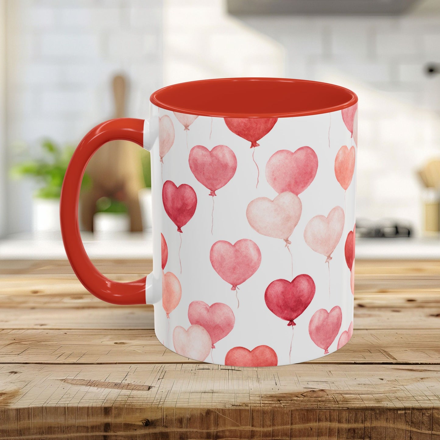 White ceramic mug with red interior and handle, featuring pink and red watercolor heart balloons.