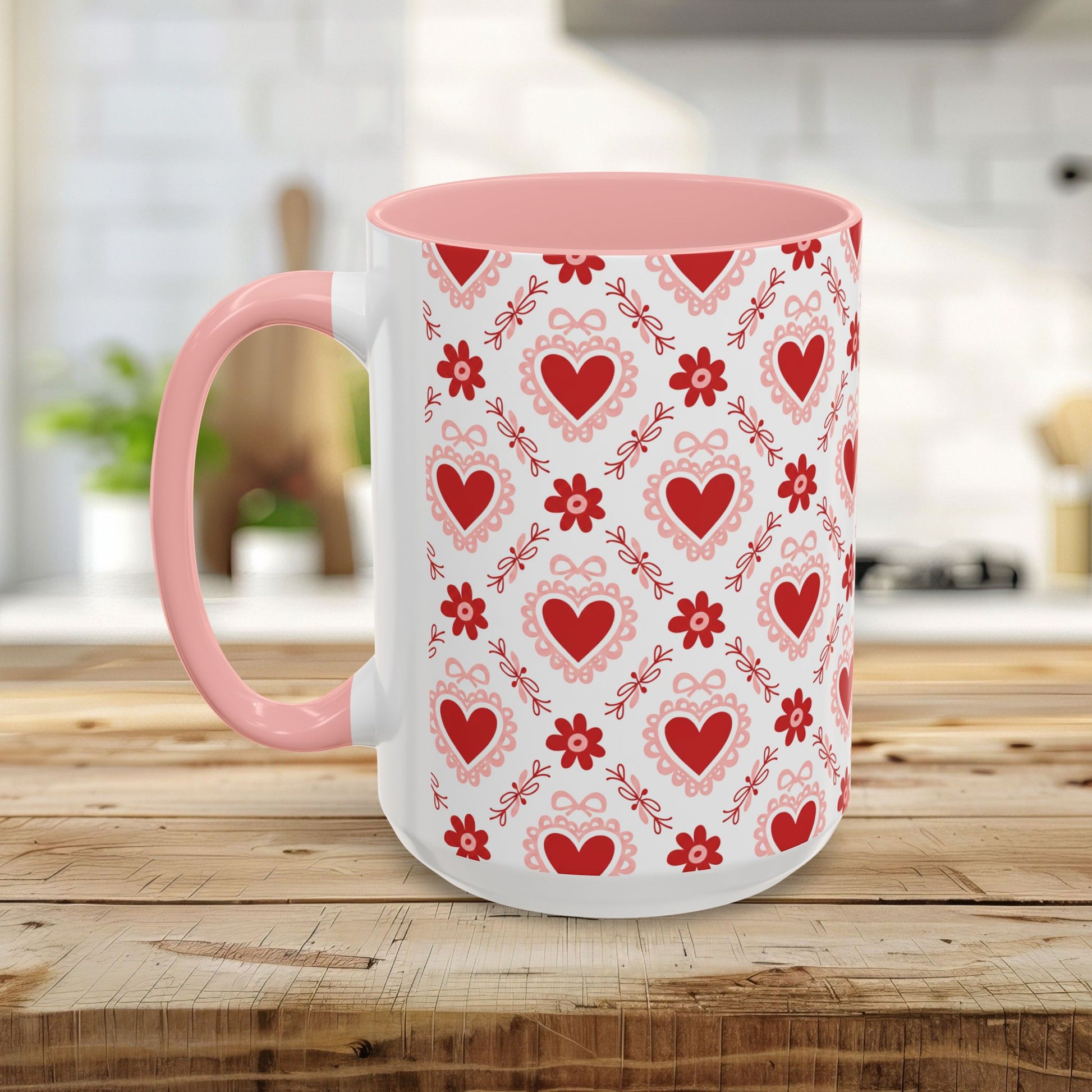 White ceramic mug with pink interior and handle, featuring a repeating red heart and ribbon pattern.