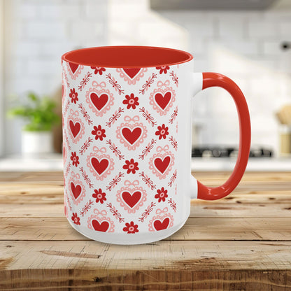 15oz ceramic mug with red interior/handle and a repeating pattern of red hearts, floral motifs, and bows.