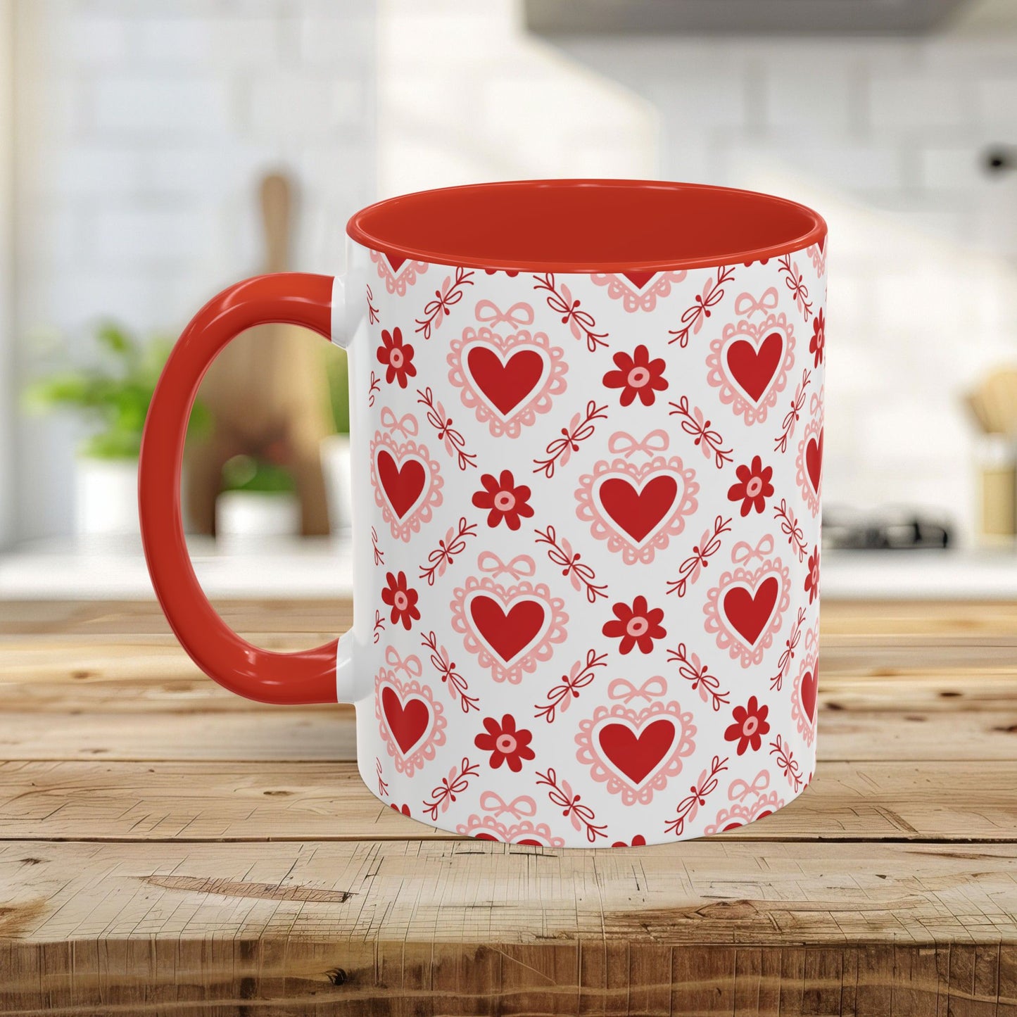 White ceramic mug with red interior and handle, featuring a repeating pattern of red hearts, floral motifs, and pink bows.