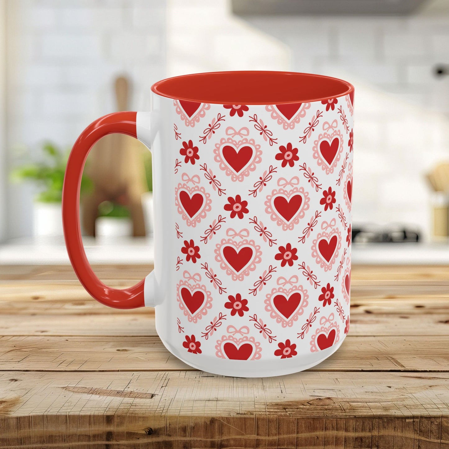 White ceramic mug with red interior and handle, featuring a repeating pattern of red hearts, floral motifs, and bows.