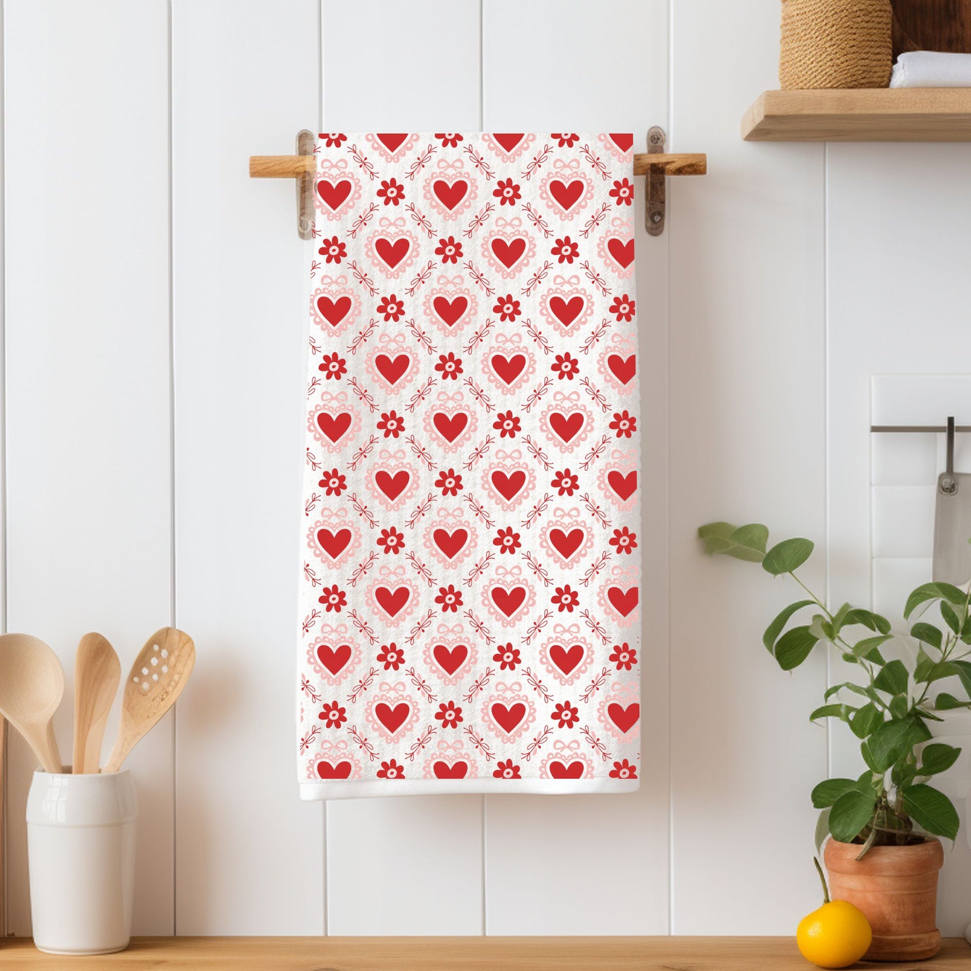 Microfiber tea towel with a repeating pattern of red hearts and pink floral motifs.