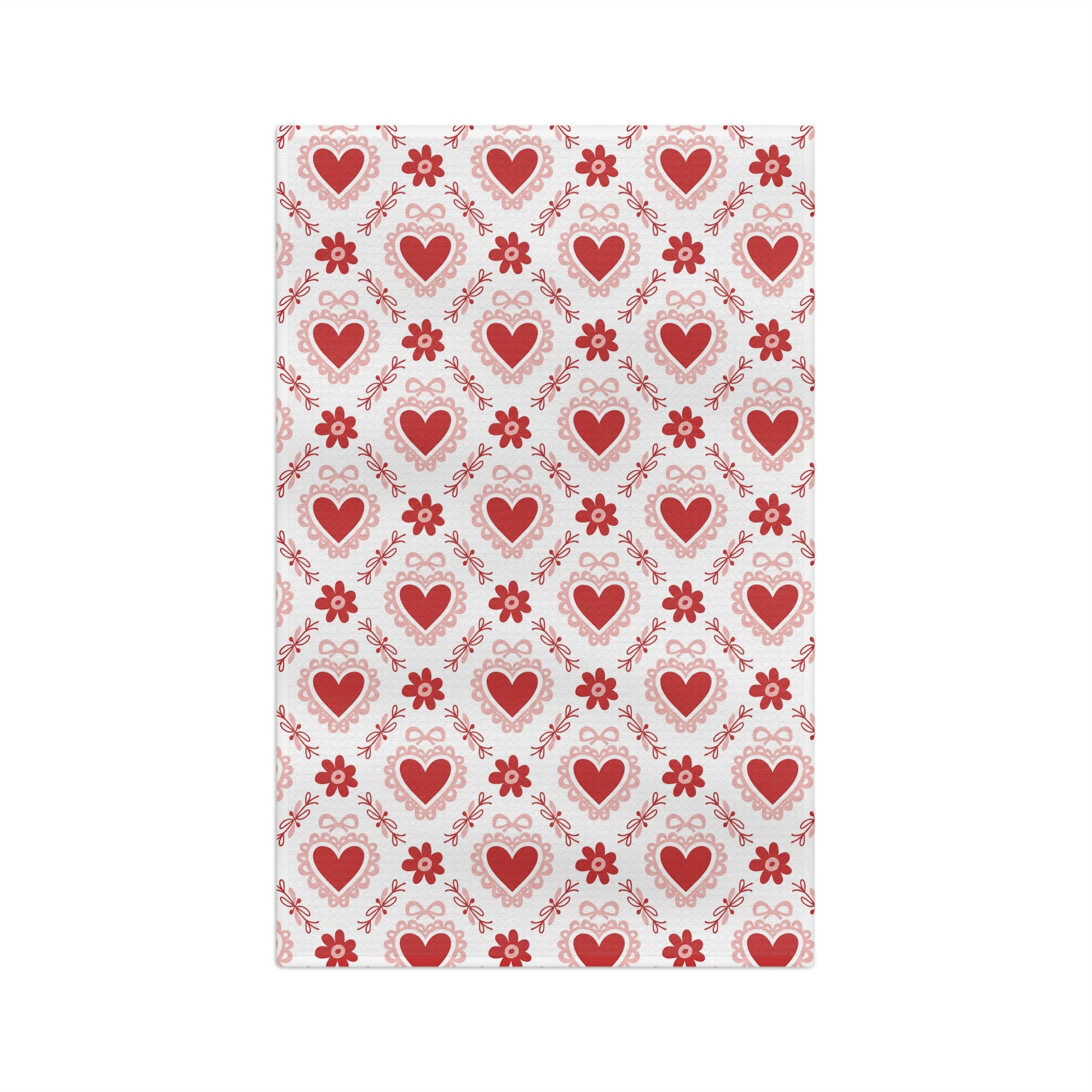 Microfiber tea towel with a repeating pattern of red hearts, pink carnations, and ribbons.