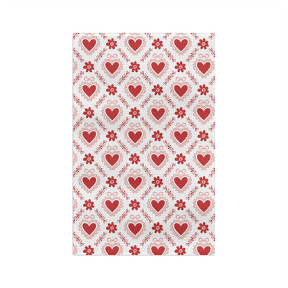 Microfiber tea towel with a repeating pattern of red hearts, pink carnations, and ribbons.