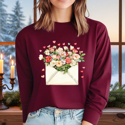 Maroon long-sleeve tee with a vintage envelope design spilling pink and cream flowers and hearts.