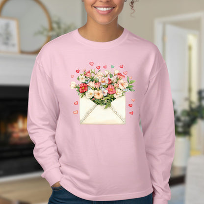 Pink long sleeve tee with a vintage envelope design spilling hand-drawn hearts and pink and cream blooms.