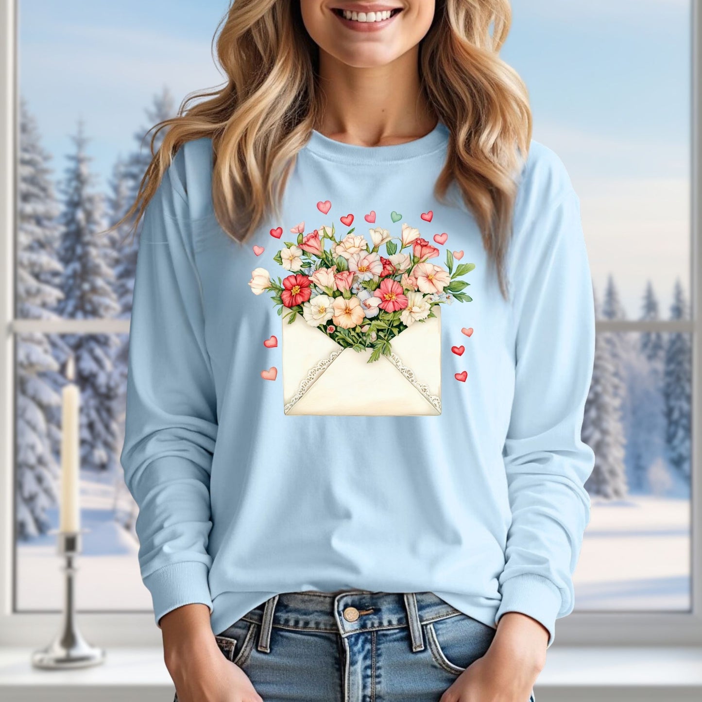 Light blue long-sleeve tee with a vintage envelope design spilling pink and cream flowers and hearts.