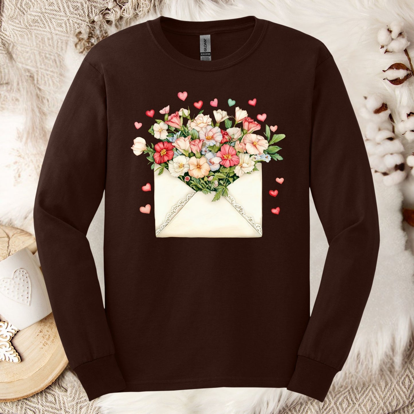 Dark chocolate long-sleeve tee with a vintage envelope spilling pink and cream flowers and hearts.