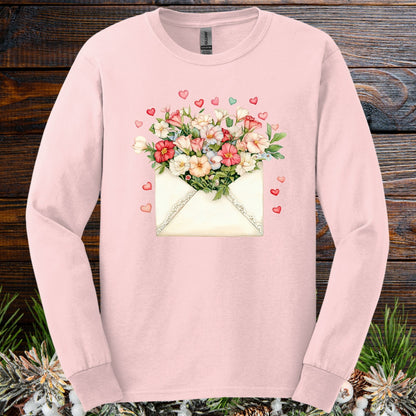Light pink long sleeve tee with a vintage envelope spilling pink and cream flowers and hearts.