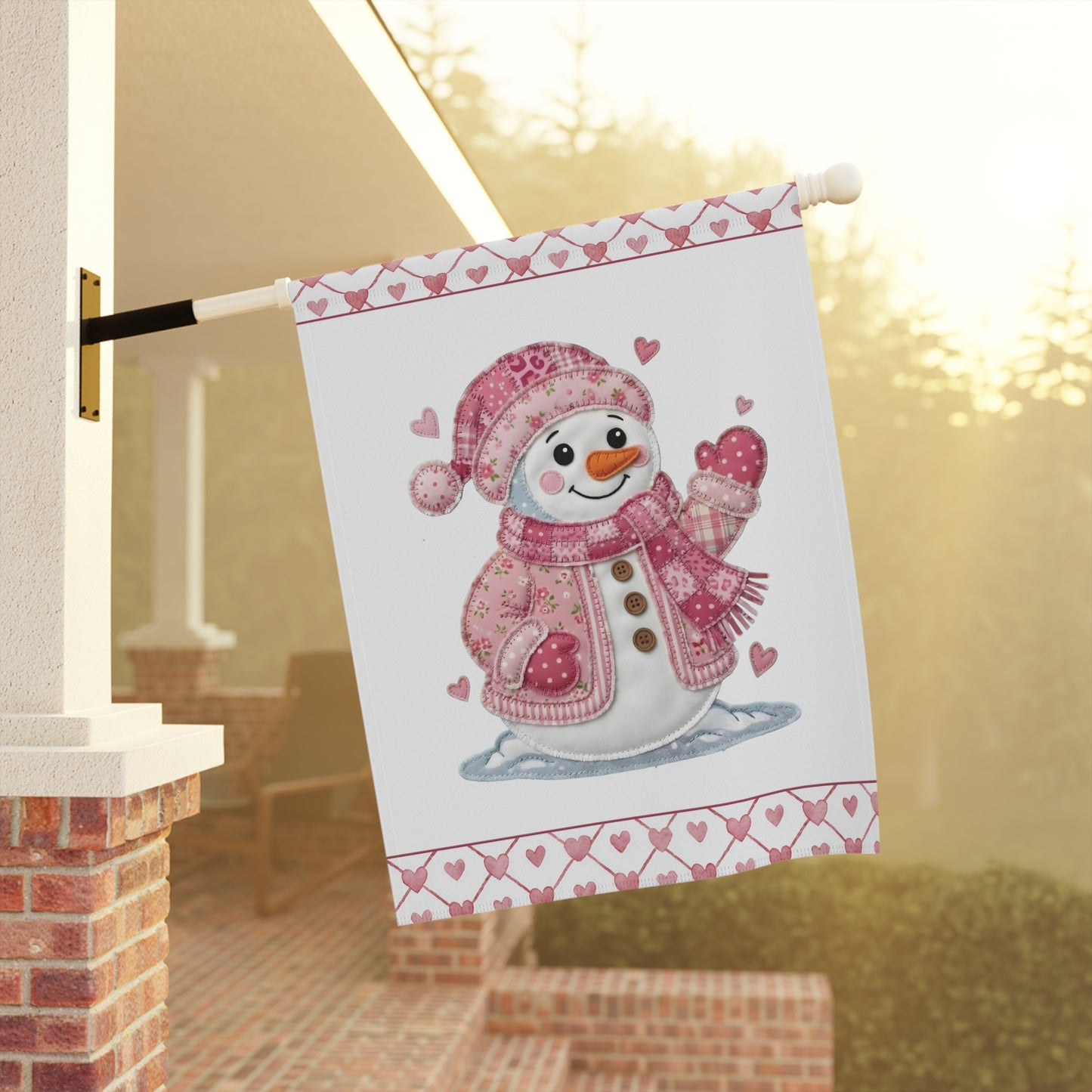 Valentine's Day pink patchwork snowman garden flag on a white poly poplin-canvas, hanging outdoors.