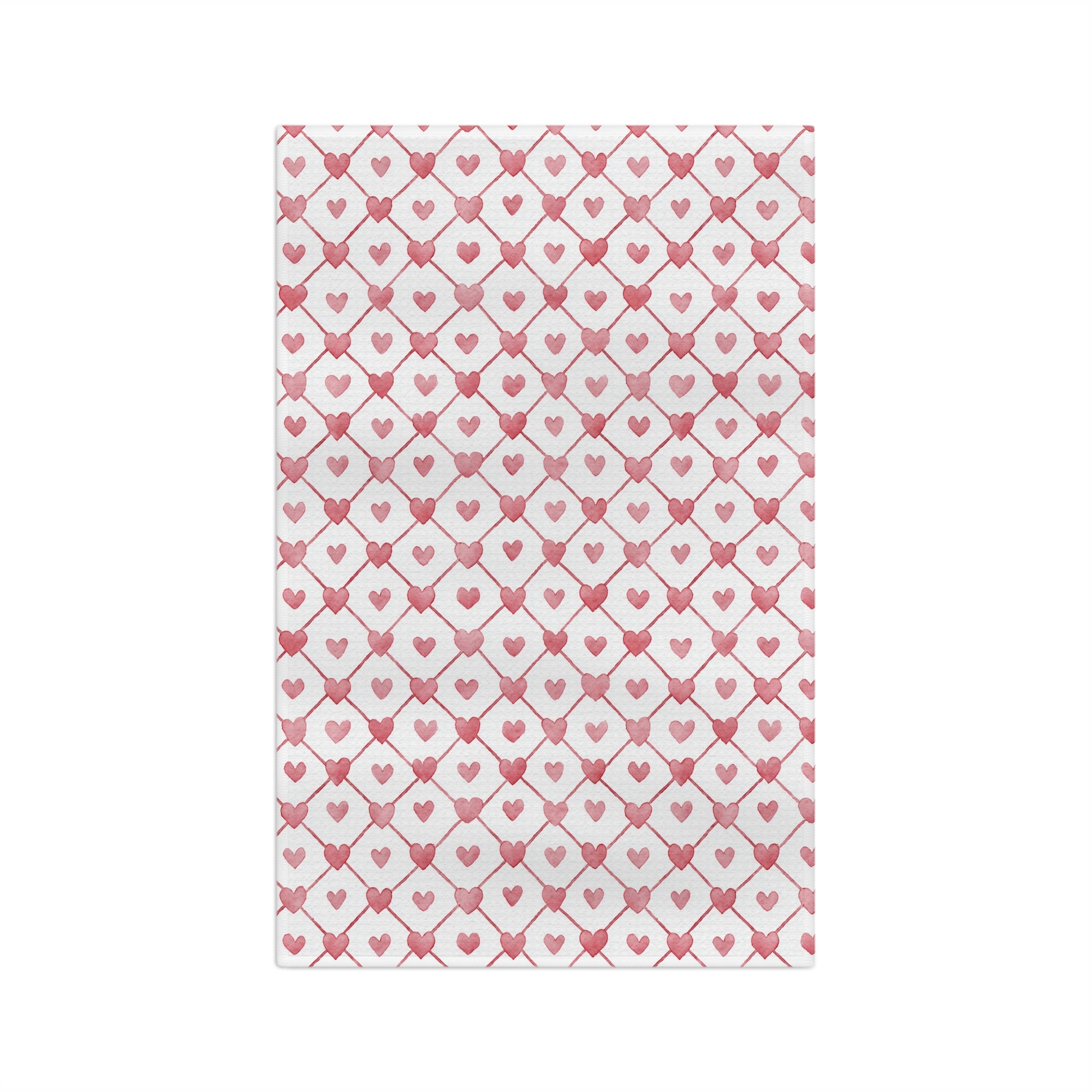 White microfiber tea towel with a geometric pattern of red hearts and diagonal lines.