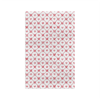 White microfiber tea towel with a geometric pattern of red hearts and diagonal lines.