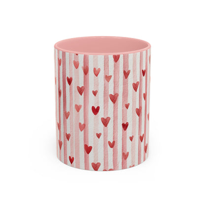 Glossy white ceramic mug with pink watercolor stripes, red hearts, and a pink interior.