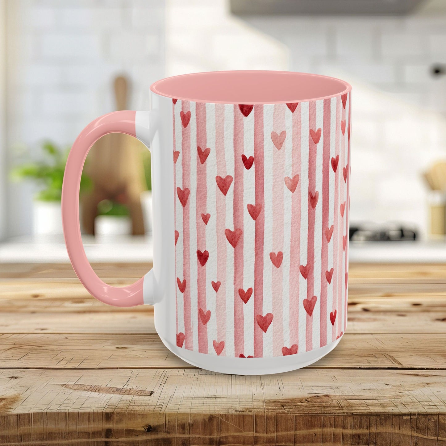 White ceramic mug with pink interior and handle, featuring watercolor pink stripes and red hearts.