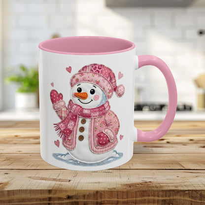 11oz ceramic mug with a pink handle and interior, featuring a rosy patchwork snow lady design.