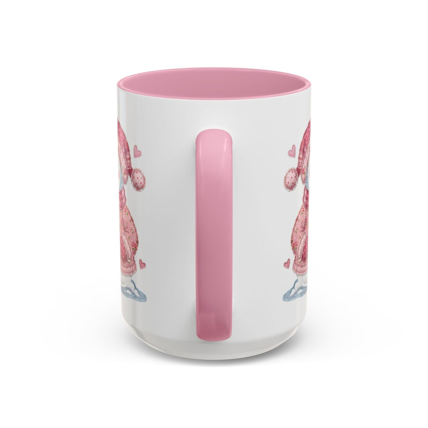White ceramic mug with pink handle and interior, featuring a patchwork snow lady design.
