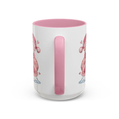 White ceramic mug with pink handle and interior, featuring a patchwork snow lady design.