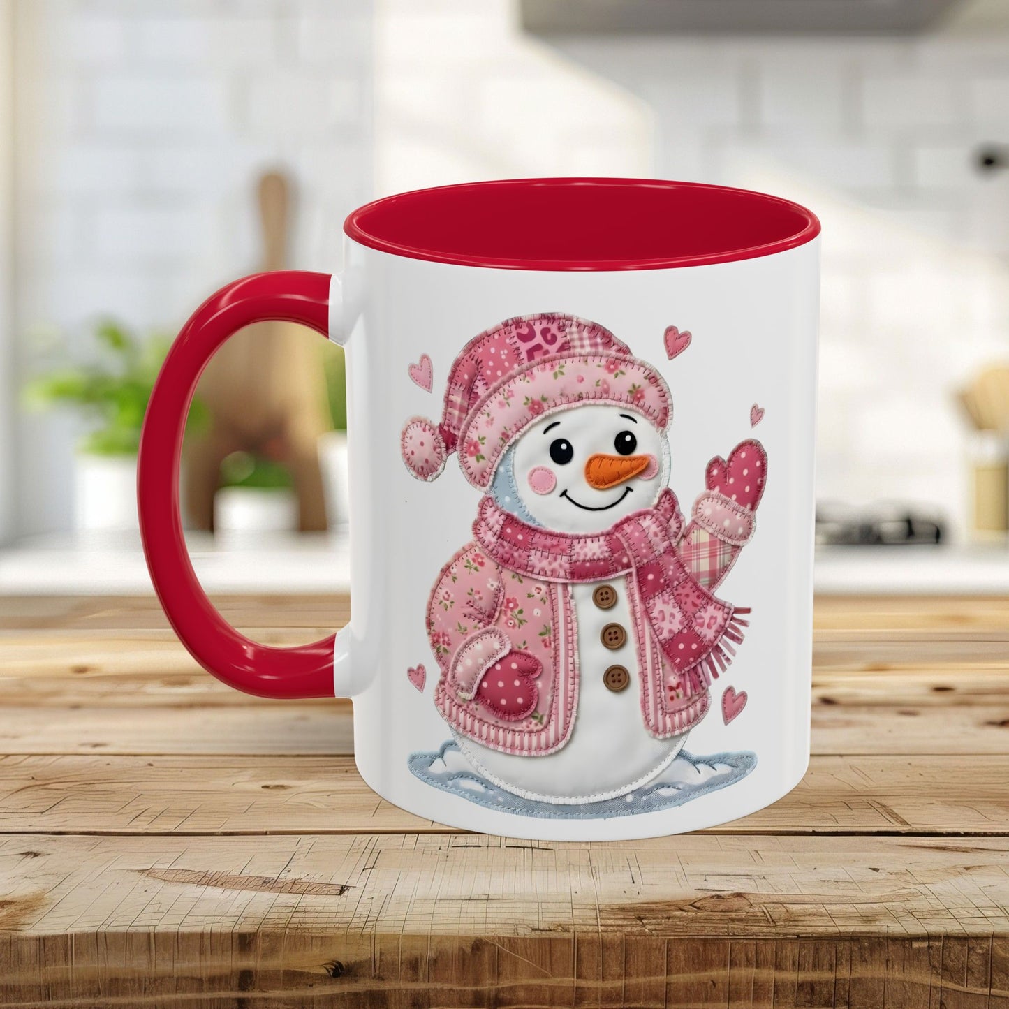 White ceramic mug with red handle and interior, featuring a rosy patchwork snow lady design.