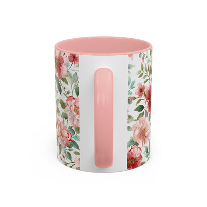 White ceramic mug with pink interior and handle, featuring a watercolor design of pink and red peonies.