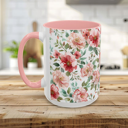 White ceramic mug with pink interior and handle, featuring a vibrant watercolor print of pink and red peonies.