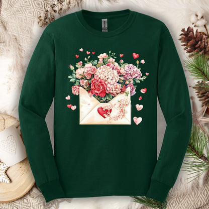 Forest Green long sleeve tee with a vintage heart envelope overflowing with red, ivory, and pink flowers.