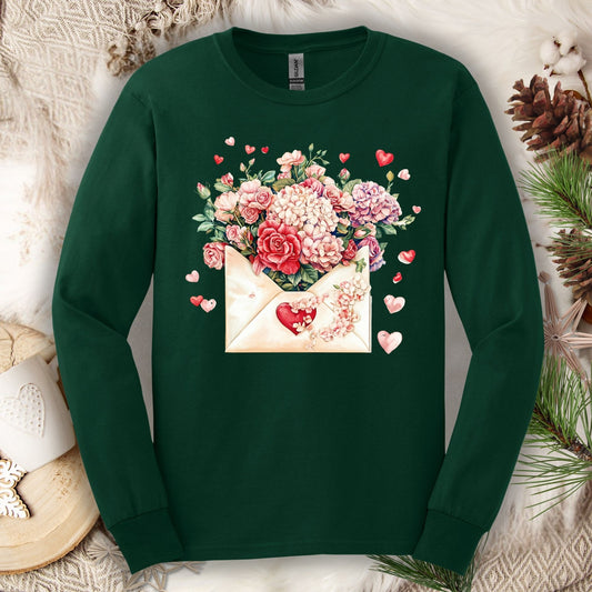 Forest Green long sleeve tee with a vintage heart envelope overflowing with red, ivory, and pink flowers.