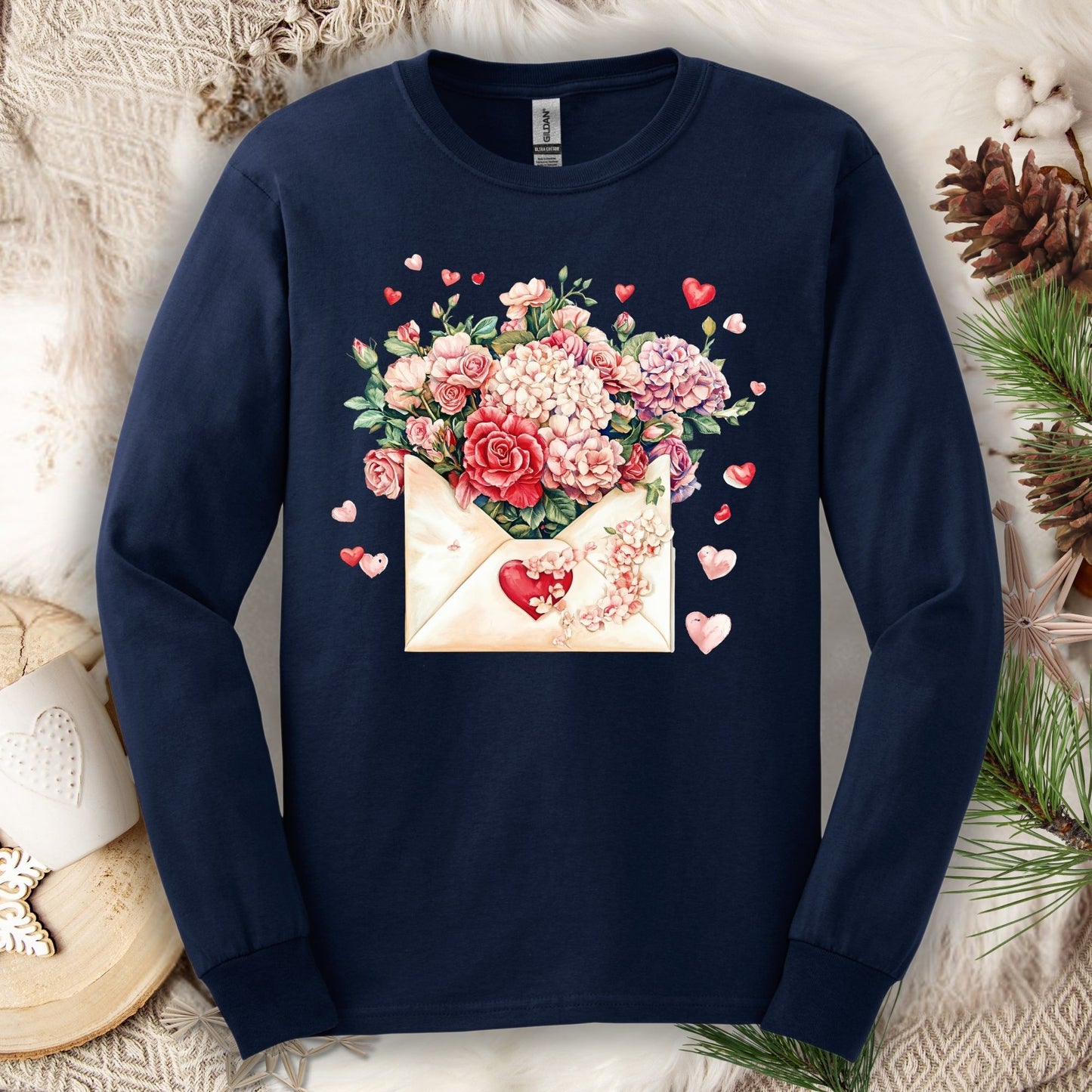Navy long sleeve tee with a vintage heart envelope overflowing with red, ivory, and pink flowers.