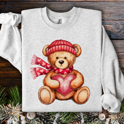Ash S sweatshirt with a teddy bear in a red hat and scarf holding a glittery red heart.