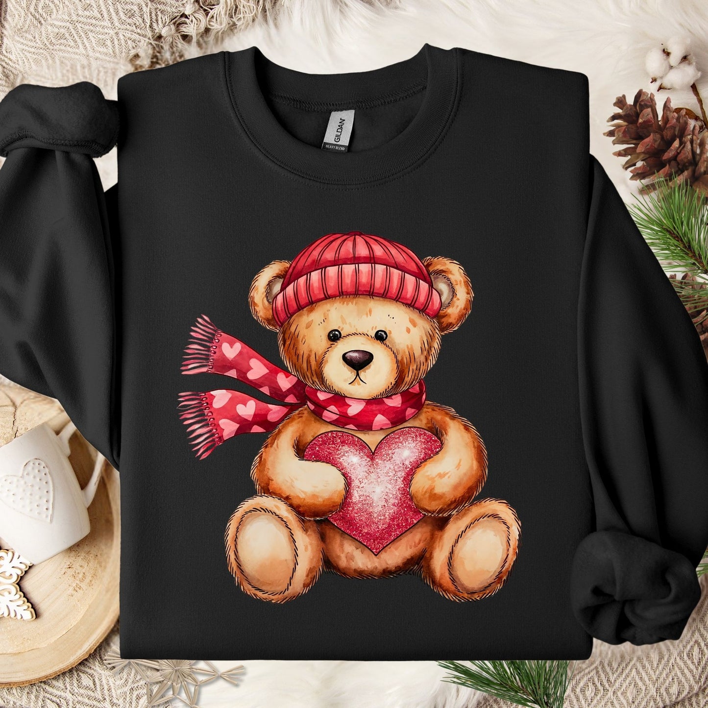 Black cotton-polyester sweatshirt with a teddy bear in a red hat and scarf holding a glittery red heart.