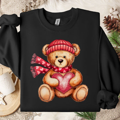 Black cotton-polyester sweatshirt with a teddy bear in a red hat and scarf holding a glittery red heart.