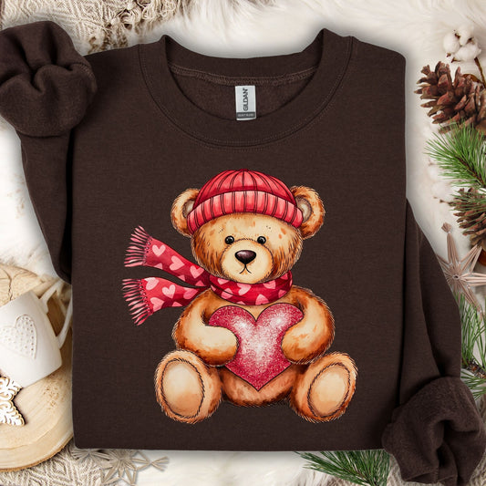 Dark Chocolate S sweatshirt with a teddy bear in a red hat and scarf holding a glittery red heart.