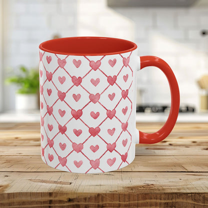 White ceramic mug with a red handle and interior, featuring a watercolor geometric heart pattern.