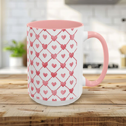 15oz ceramic mug with pink interior/handle and watercolor geometric heart pattern.