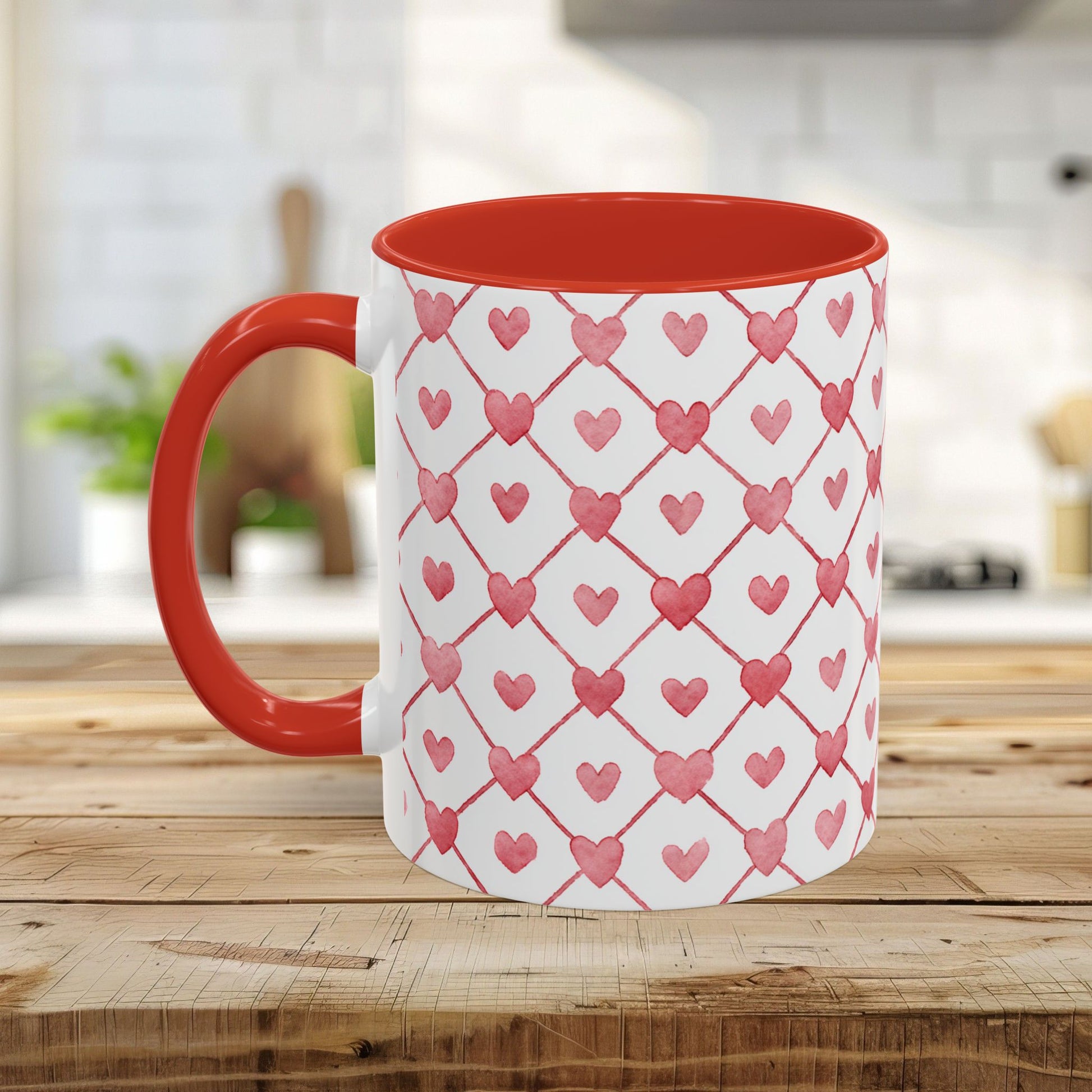 White ceramic mug with a red handle and interior, featuring a watercolor geometric heart pattern.